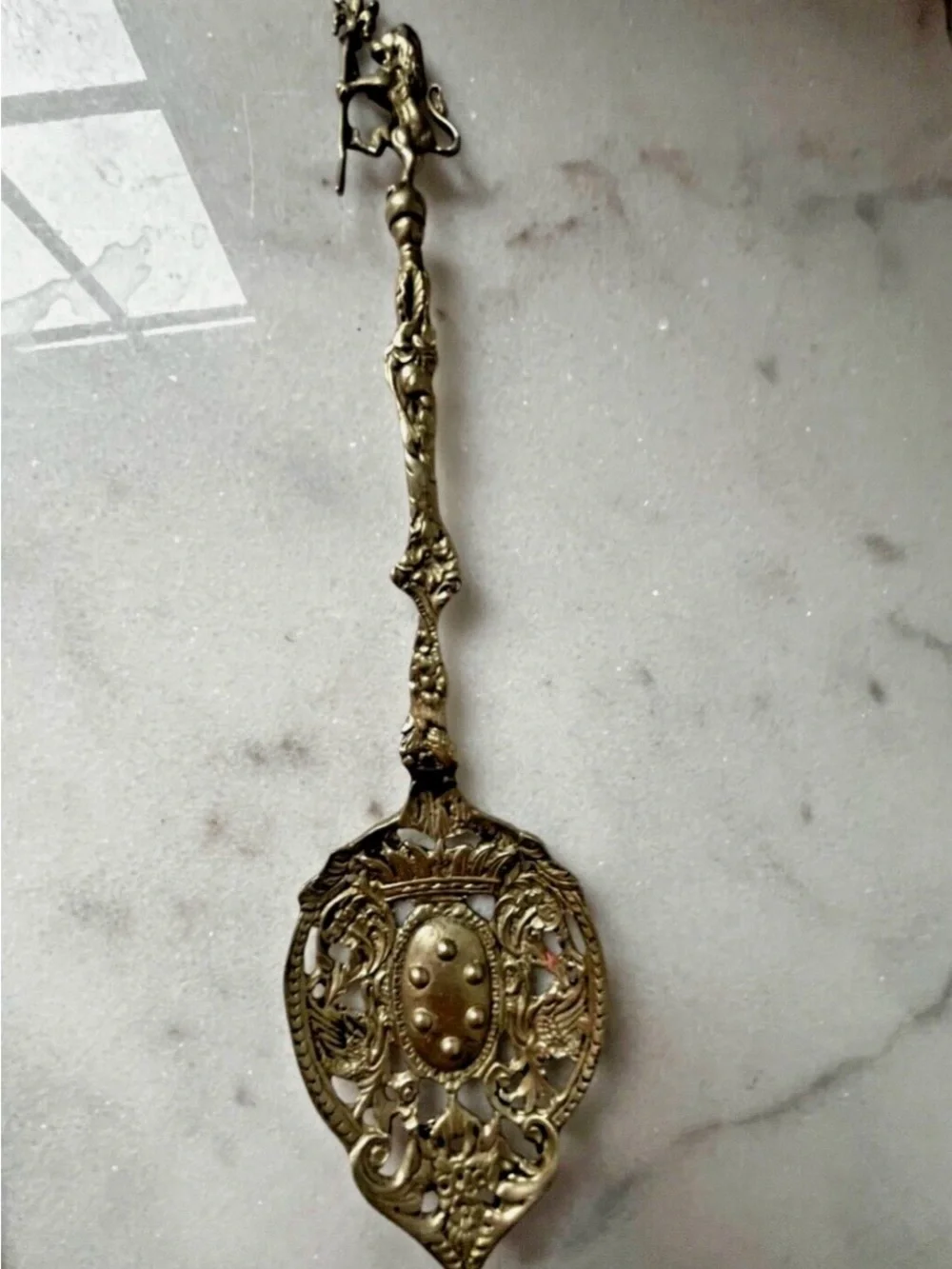 vintage Italian serving utensils are an ornate brass fork and spoon set